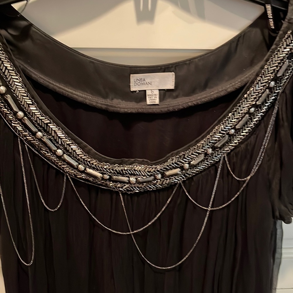 Gorgeous mini black dress with silver chain and accessories.